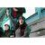 Image of a woman sitting in bleachers and cheering. She is wearing a dark charcoal Fleece Beanie, a gray shirt and a red/black plaid vest.