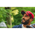 Image of bearded man looking up to the sky in front of green trees and wearing a Flannel Curveball Cap.