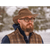 Man with glasses wearing a brown, waxed Backwoods Cruiser hat outside with a snowy background.