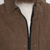 The Squall coat in Dark Oak waxed cotton close up of zipper. The Squall coat in Dark Oak waxed cotton close up of zipper.