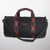 The Signature Duffel in black with red/black plaid straps.
