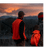 Two men bird hunting. One wearing a blaze orange vest.
