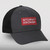 Trucker cap with charcoal front and bill with a black mesh back and a red and white Stormy Kromer logo.