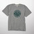 A sport gray short sleeve tee with a printed graphic of a man in a canoe with a dog in a circle stamp.