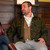 Man sitting wearing an olive Wool Overshirt and a tan vest