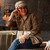 Lady sitting at a bar wearing a Cottage Overshirt and Woodlands Cap