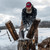 Man splitting wood outside wearing a Frontier Shirt Jack and ballcap