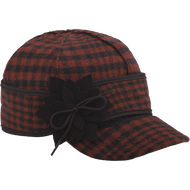 A 45 degree angle view of The Petal Pusher Cap: a wool, six-panel winter cap with a pulldown earband that ties off to the side with a wool flower, and a brim.