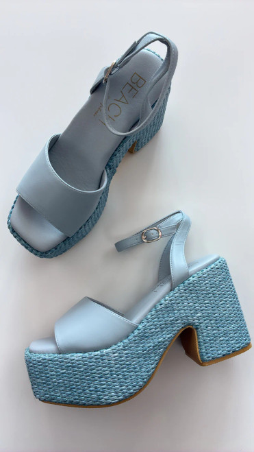 The Arden vegan platform sandal by Beach by Matisse showcases a rich cognac faux leather upper paired with a statement woven platform and ankle strap.
