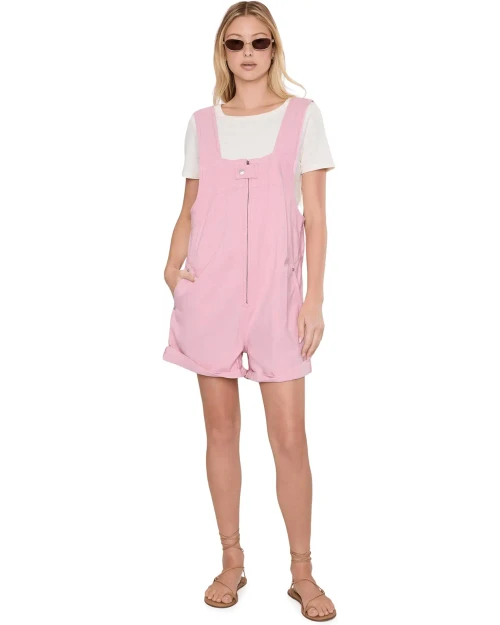 The Free People™ We The Free Jude Shortalls feature a slouchy shapeless silhouette and classic pinafore design for a timeless touch. It features a square neckline with a zippered front closure and offset button tab, giving it a modern utilitarian edge. The four-pocket design adds both function and style, making it a versatile option that blends casual ease with structured detailing.