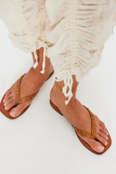 Chase the sun or lounge away in these effortlessly cool flip flops from FP Collection, featuring smooth leather thong straps with studded embellishments and a squared open toe for an easy style with endless character.

Leather thong straps with metal embellishments
Slip-on flip flops
Leather outsole
Short block heel