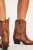Ankle length, pull-on style, leather uppers, pointed toe, western-style stitching, dipped toplines, pull straps, block heel