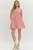 Red gingham sleeveless mini dress featuring a fun flirty fit. Button closure at front with side pockets. Lined, non sheer & lightweight.