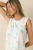 Bring a playful, country club touch to your lounge collection with the Court Sports Pajama Tank by Z Supply. Featuring a colorful print of tennis rackets, pickleball paddles, golf carts, cocktails, palm trees, and other resort style imagery, this lightweight knit tank is designed for comfort and easy wear. The sleeveless silhouette, classic round neckline, and relaxed fit make it perfect for warm nights, slow mornings, and laid-back weekends. Pair it with the matching shorts or pants for a coordinated sleep set that's equal parts fun and comfortable.