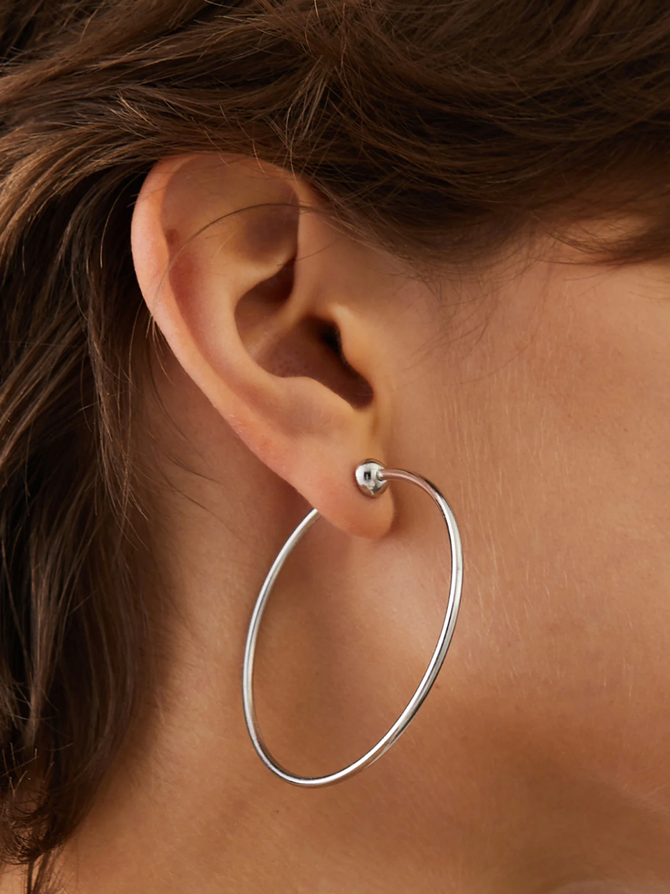 Jenny Bird Medium Icon Hoops in Silver on Model 1

