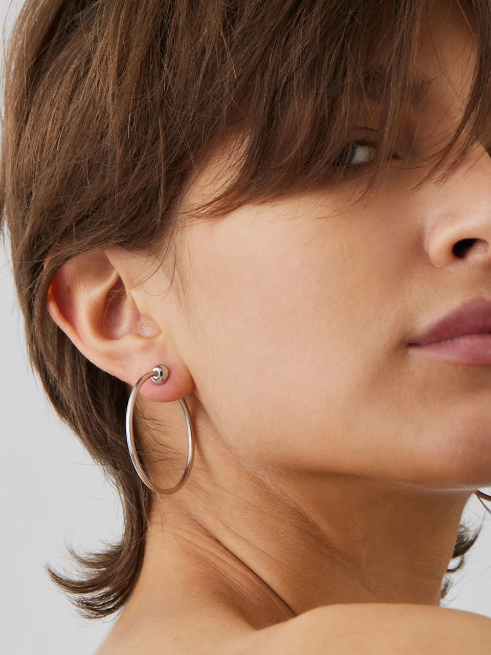 Jenny Bird Small Icon Hoops in Silver on Model 2