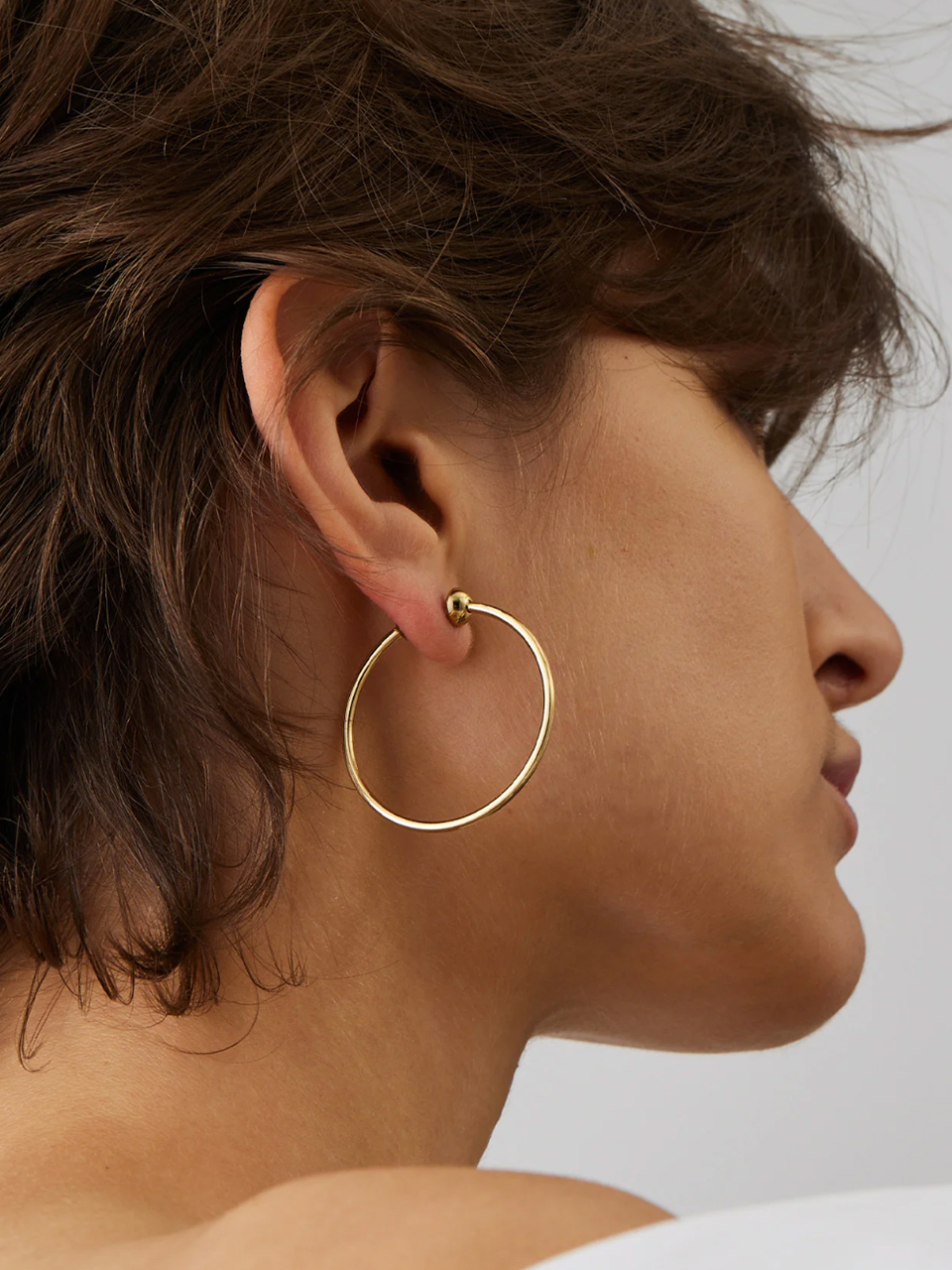 Jenny Bird Small Icon Hoops in Gold on Model 1