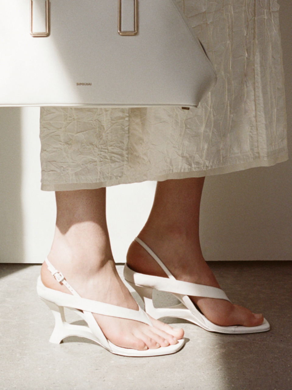 SIMKHAI Darya Leather Wedge Thong Sandal in Alabaster on Model 
