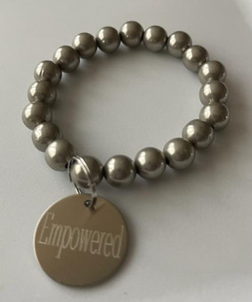 Silver bracelet with Empowered on tag