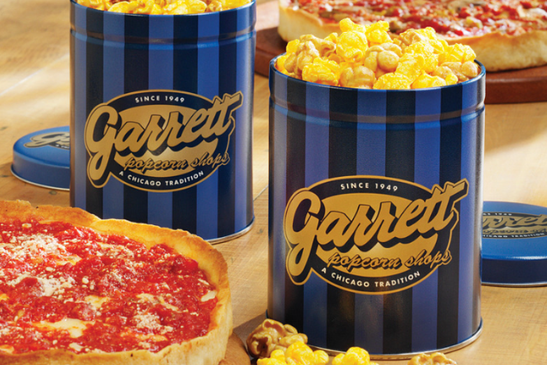 Two Garrett popcorn tins with deep dish pizza