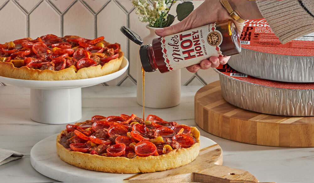 Mike's Hot Honey Pizza with Mike's Hot Honey being drizzled on top.