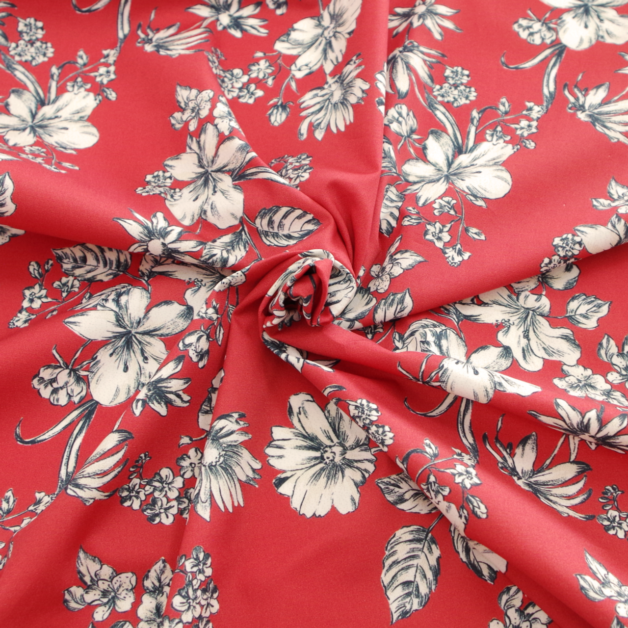 Flower printed red cotton poplin. Designer deadstock fabric cut to length.  Sold by units of 10 cm (1 mt= 10 units)