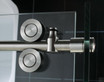 Frameless Dreamline Enigma shower enclosure hardware with sleek stainless steel rollers and glass panel
