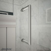 Chrome handle for DreamLine Unidoor-X hinged shower door mounted on a tiled wall