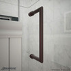 DreamLine Unidoor-X shower door handle in a dark finish, mounted on a marble wall