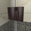 Hinged shower door hardware with a sleek dark finish