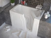 Compact walk-in bathtub by Meditub, with a low threshold entry, modern design, and surrounded by bathroom accessories