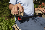 Hand gripping the control lever of a Bruno Elite outdoor stair lift