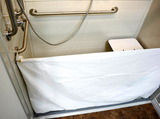Attendant shower curtain in a barrier-free shower setting, with a heavy-duty vinyl design