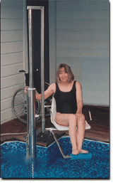 Aquatic Access pool lift with 180-degree rotation lowering a seated user toward the pool
