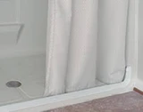 Weighted shower curtain in a curbless shower setting