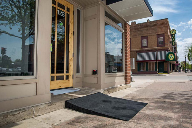 Rubber threshold ramp installed at a commercial entrance