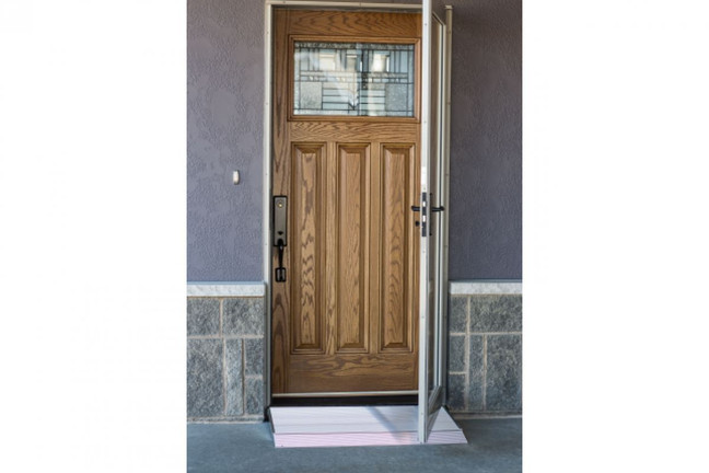 Curb ramp positioned at the entrance of a home, facilitating accessibility for individuals with mobility challenges