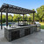 Luxury poolside outdoor kitchen featuring a NorCal Ovenworks Split Santa Maria Built-In Grill set in a stone masonry island under a pergola, showcasing the seamless drop-in design.