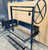 Side view of the black steel Argentine grill kit, stainless steel V-grate, and side brasero, with a wind block. Side view of the black steel Argentine grill kit, stainless steel V-grate, and side brasero, with a wind block.