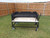 Fully welded Pro-Series Asado Fire Table with all-terrain casters, lined with split firebricks, featuring a large black asado grill and 3-sided windscreen.