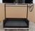 Front view of the Model 241143 Built-In Argentine Grill featuring a black steel finish, open-front firebox, and a large side wheel for height adjustment.