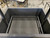 Close-up detail of the round rod grilling grate, emphasizing its robust design for charcoal and wood burning.