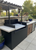 Commercial-quality Argentine-style outdoor cooking unit with an integrated, manual lift mechanism and sturdy black metal construction.