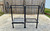Split architectural grill kit configured with one Argentine V-grate and one classic round-rod grate for solid-fuel versatility.