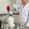 Scientist pouring chemicals into an ECO Funnel Scientist pouring chemicals into an ECO Funnel