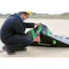 UltraTech Economy Berm, 30 mil RPE, 6' x 6' x 1' - a worker setting up a black and green protective barrier on a construction site.