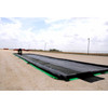 UltraTech Ground Tarp Plus, 12' X 52', 130 mil, laid out on a dirt surface in an outdoor setting.