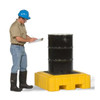 UltraTech Spill Pallet P4 Plus, With Drain, Yellow, used for storing and containing industrial barrels, with a man inspecting it.