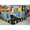 Justrite Rigid-Lock QuickBerm All-In-One 8' x 10' x 12" Drive-Over Spill Containment Berm, 595 Gallon, Black, for Vehicle Access Oil & Chemical Spill Control, with gray drums and a forklift in an industrial warehouse setting