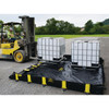Justrite Rigid-Lock QuickBerm All-In-One 8' x 10' x 12" Drive-Over Spill Containment Berm, 595 Gallon, Black, for Vehicle Access Oil & Chemical Spill Control - image shows a forklift placing two intermediate bulk containers on a black spill berm with yellow straps outdoors.